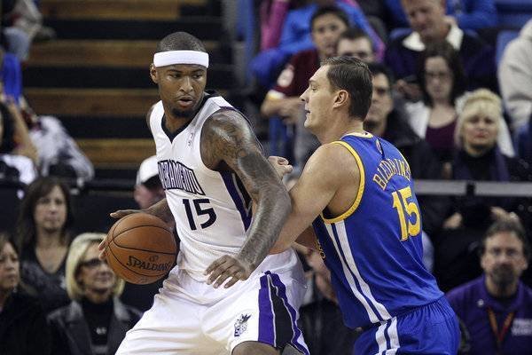 Dec 19, 2012; Sacramento, CA, USA; Sacramento Kings center DeMarcus Cousins (15) controls the ball against Golden State Warriors power forward Andris Biedrins (15) during the first quarter at Sleep Train Arena. Mandatory Credit: Kelley L Cox-USA TODAY Sports ORG XMIT: USATSI-95718